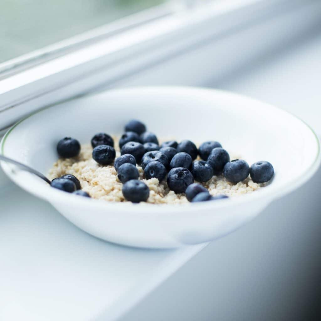 A bowl of oatmeal with blueberries