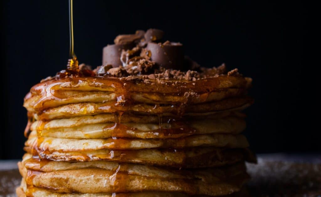 Pancakes decadently topped with dark chocolate and syrup