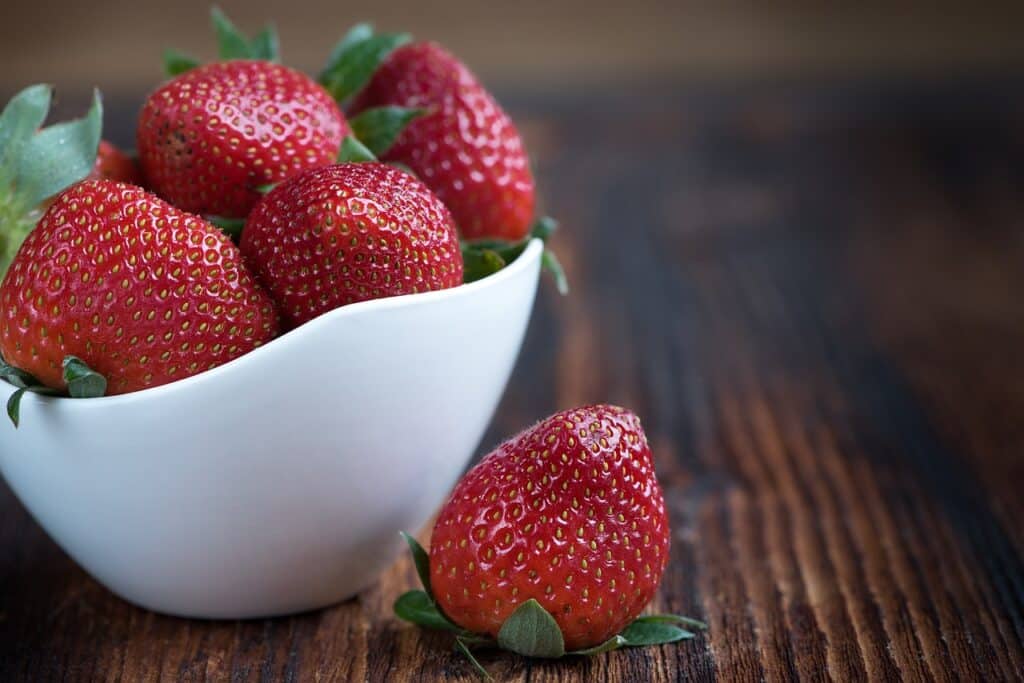 A bowl of fresh strawberries is a healthy breakfast option